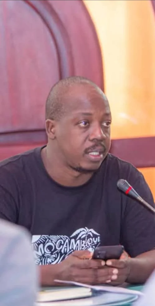 Ange David Baimey speaking at a meeting