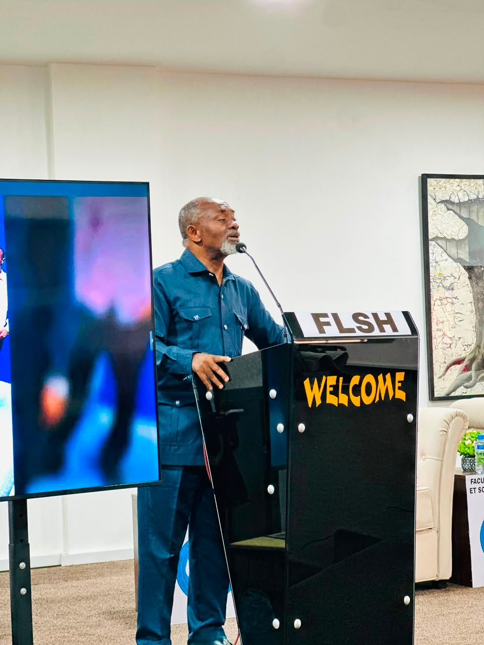 Dr. Gnaka Lagoke speaking at a podium