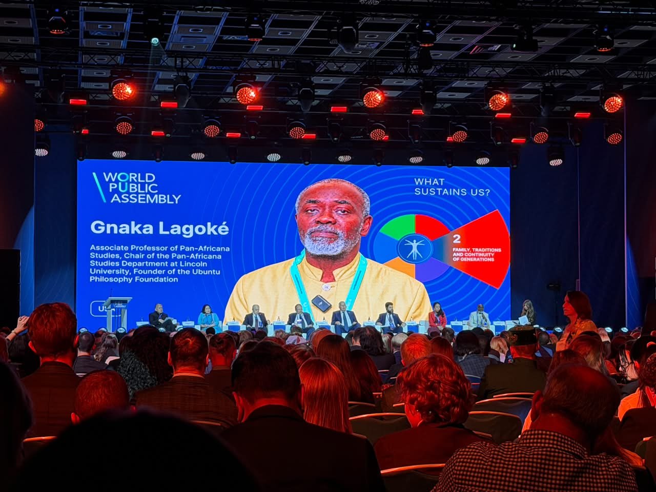 Le Dr Gnaka Lagoke sur l’écran principal lors d’une table ronde de l’Assemblée publique mondiale à Moscou, vu depuis la salle