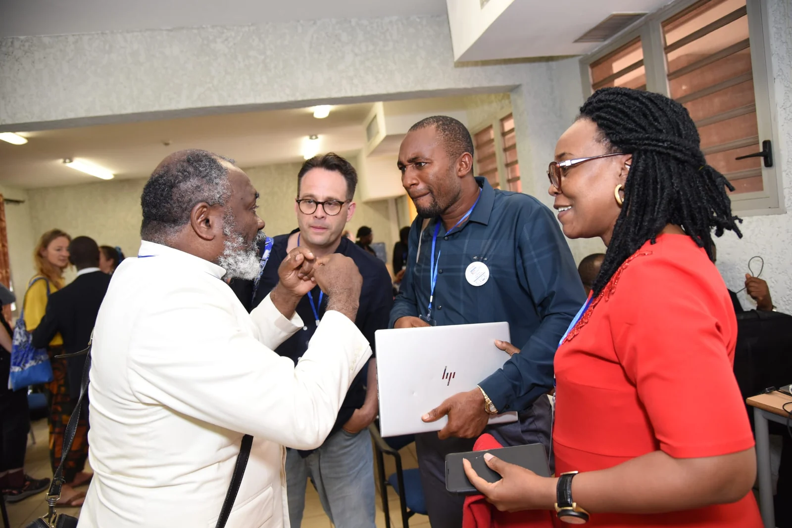 Dr. Gnaka Lagoke in conversation with participants at an international gathering